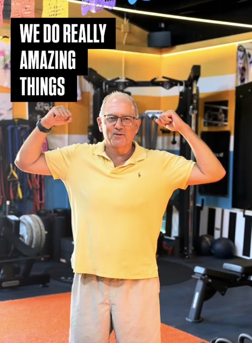 Frank, six months after his hip replacement, flexing on the gym floor at Lilley Fitness.